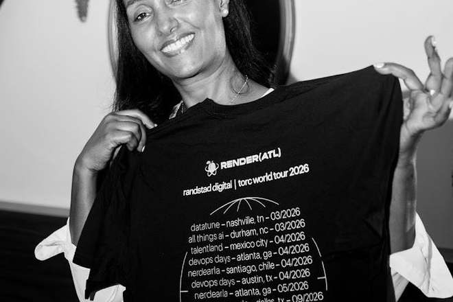 a community member holding up the randstad digital and torc world tour shirt